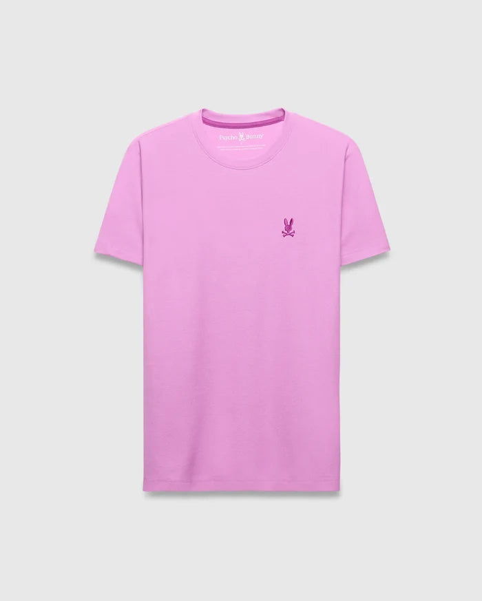 Mens Taylor Pique Tee in vibrant lavender, featuring a classic fit and subtle pique texture. A small, embroidered dark pink Psycho Bunny skull logo is on the left chest, with matching neck trim.