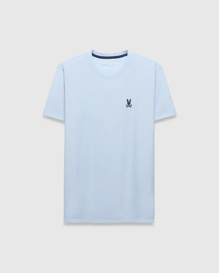 Mens Taylor Pique Tee, a light blue classic fit t-shirt with a pique texture, featuring a small embroidered navy Psycho Bunny skull logo on the left chest and navy inner collar trim.