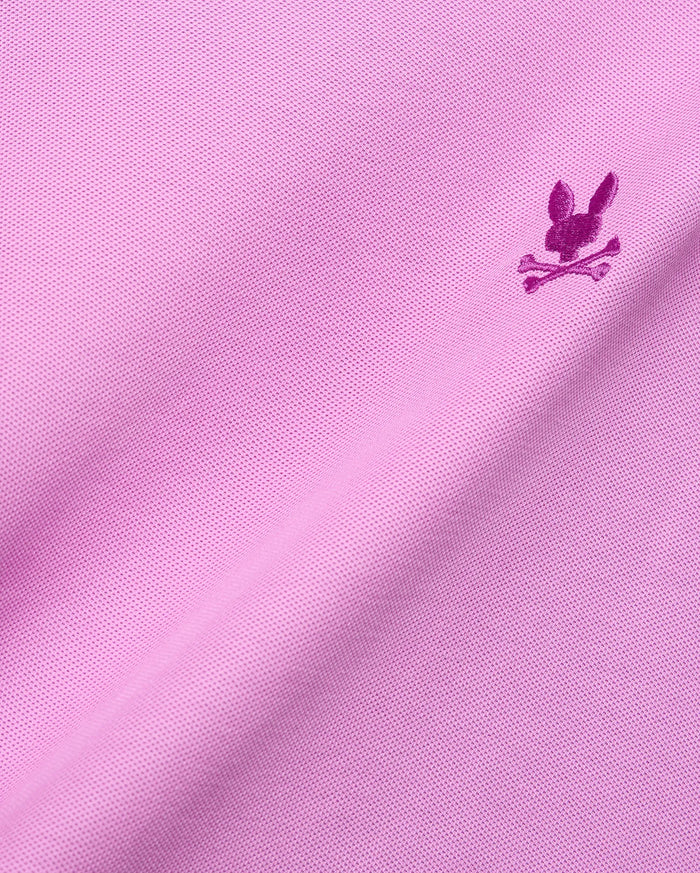 Vibrant pink Mens Taylor Pique Tee with classic pique knit texture and a small, embroidered magenta Psycho Bunny skull logo on the chest.