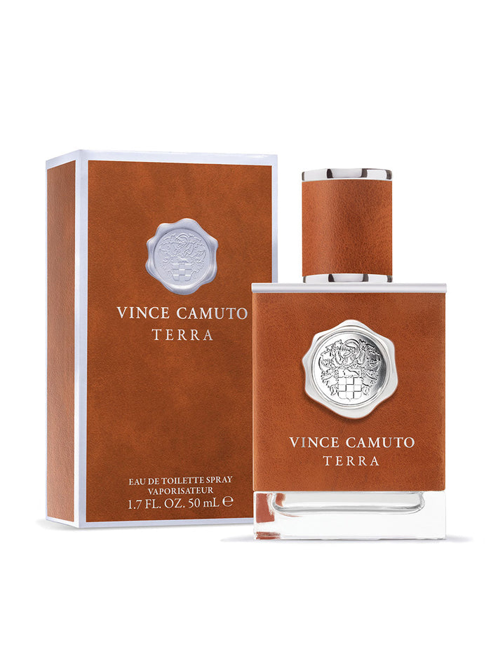 A 1.7 oz bottle and box of Vince Camuto Men’s Terra Eau de Toilette Spray, both styled in brown with silver accents and white lettering. This masculine fragrance is distinguished by a silver emblem on the bottle and combines invigorating Sicilian bergamot with modern woods for a bold, contemporary scent.