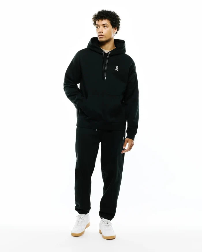 Mens Terrence Fleece Hoodie in dark green, relaxed fit, French terry fabric, kangaroo pocket, white embroidered Psycho Bunny skull logo on left chest, and white drawstrings.