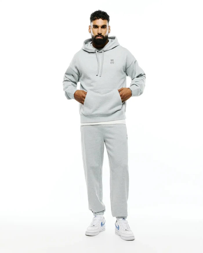 Mens Terrence Fleece Hoodie in light grey, featuring a relaxed fit, soft French terry fabric, drawstring hood, kangaroo pocket, and a small embroidered Psycho Bunny skull logo on the left chest.