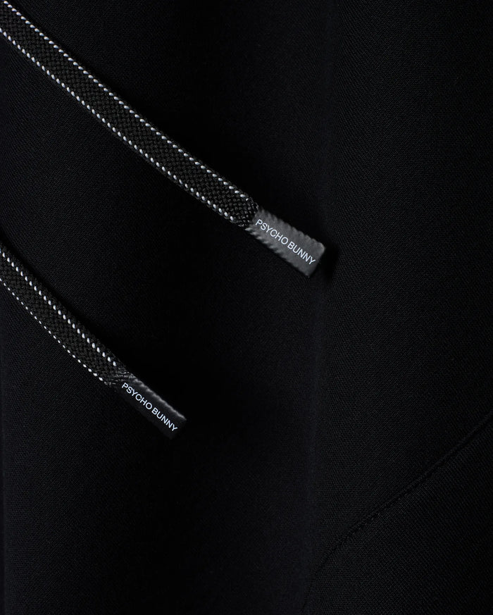 Mens Terrence Fleece Hoodie, black with soft fleece texture, featuring black drawstrings with white dotted accents and Psycho Bunny branded aglets.