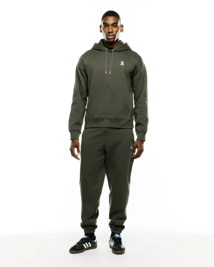 Olive green relaxed fit brushed fleece hoodie with white drawstring and embroidered Psycho Bunny skull chest logo. Paired with Mens Terrence Brushed Fleece Sweatpant, featuring an embroidered bunny skull thigh logo.