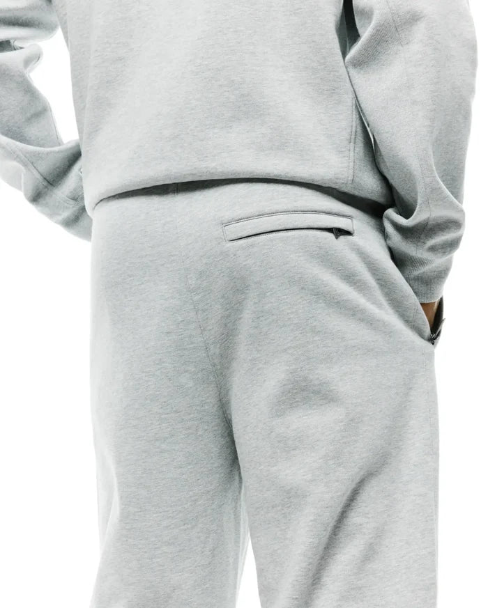 Mens Terrence Brushed Fleece Sweatpant in light grey marl, offering a relaxed fit, soft brushed fleece texture, a zippered back pocket, and convenient side pockets.