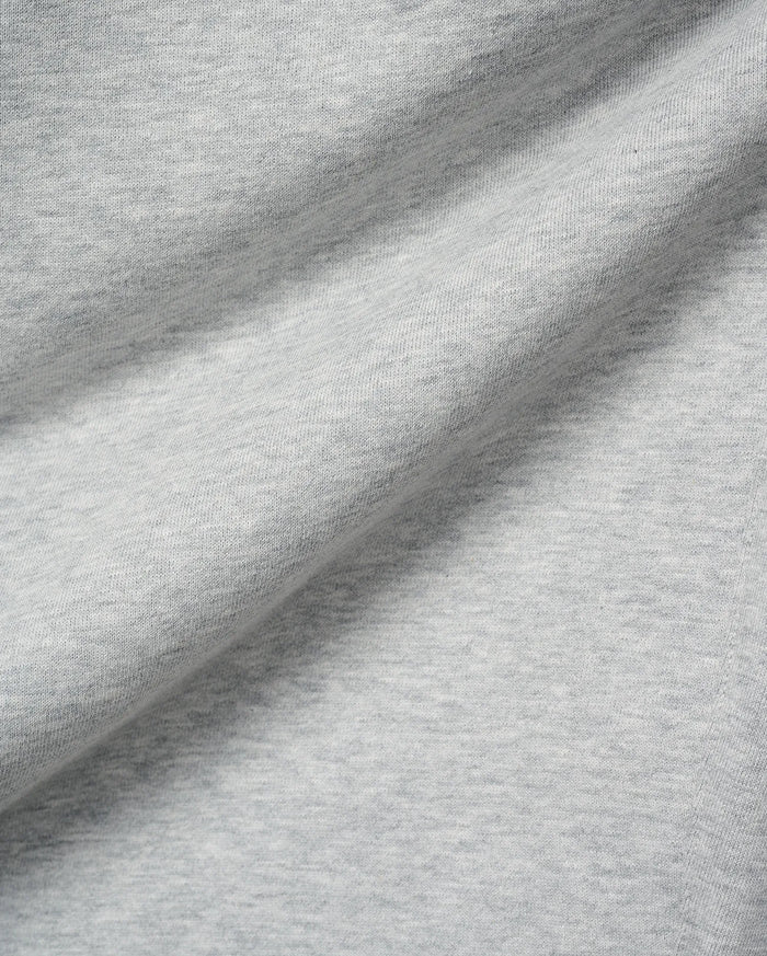 Mens Terrence Brushed Fleece Sweatpant, featuring a soft, light grey heathered brushed fleece fabric with a subtle knit texture and gentle folds.