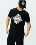 Mens Tobias Graphic Tee, a classic fit black jersey t-shirt featuring a large white Psycho Bunny skull and crossbones graphic logo with PSYCHO BUNNY text on the chest, and a small orange side tag.