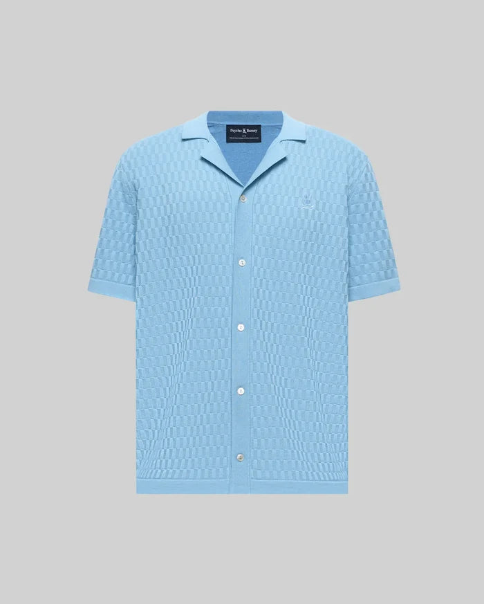 Mens Xandros Knit Shirt, light blue with a checkerboard knit pattern, featuring a spread collar, short sleeves, full button-front, and a small embroidered Psycho Bunny skull logo on the left chest.