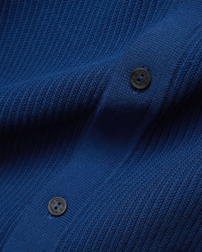 Mens Yann Knit Shirt in vibrant royal blue, featuring a premium, refined, subtly textured knit fabric and dark, branded Psycho Bunny buttons.