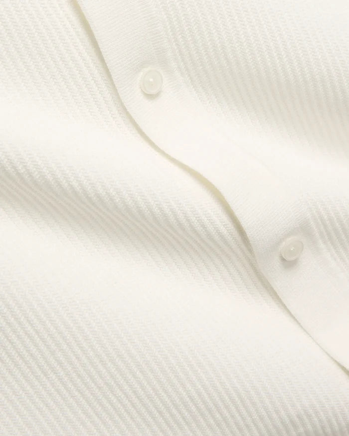 Mens Yann Knit Shirt by Psycho Bunny, a crisp white knit top with a subtle diagonal chevron pattern, featuring a clean button placket with translucent buttons.
