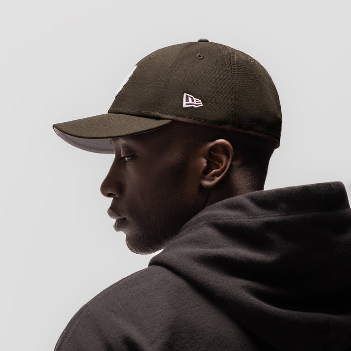 New Era 59Fifty Low Profile Hat in dark earth, worn by model in profile view