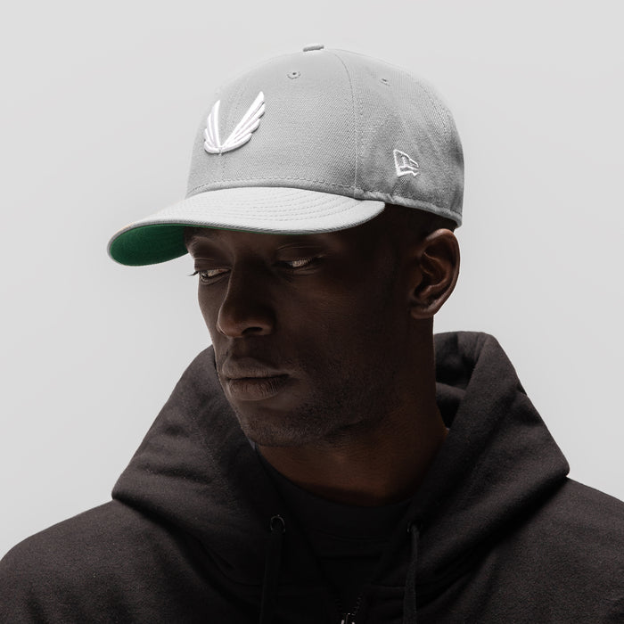 New Era 59Fifty Low Profile Hat in grey/white with wings logo, worn by model
