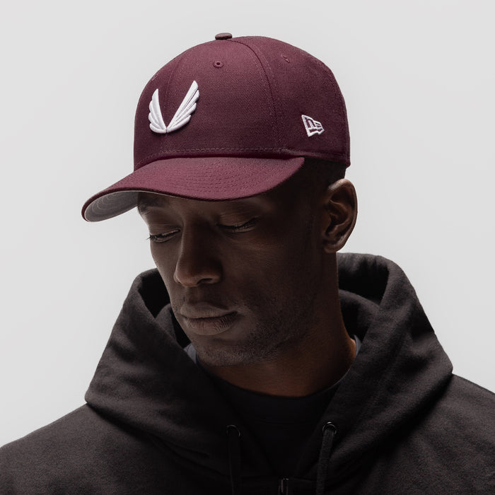 New Era 59Fifty Low Profile Hat in maroon with white wings logo, worn by model
