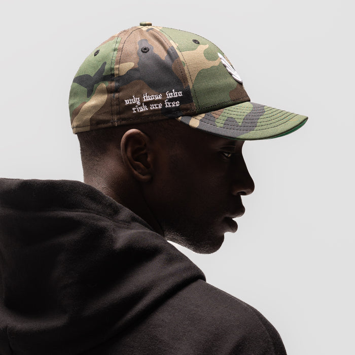 New Era 59Fifty Low Profile Hat in Woodland Camo/White, worn by model in profile view