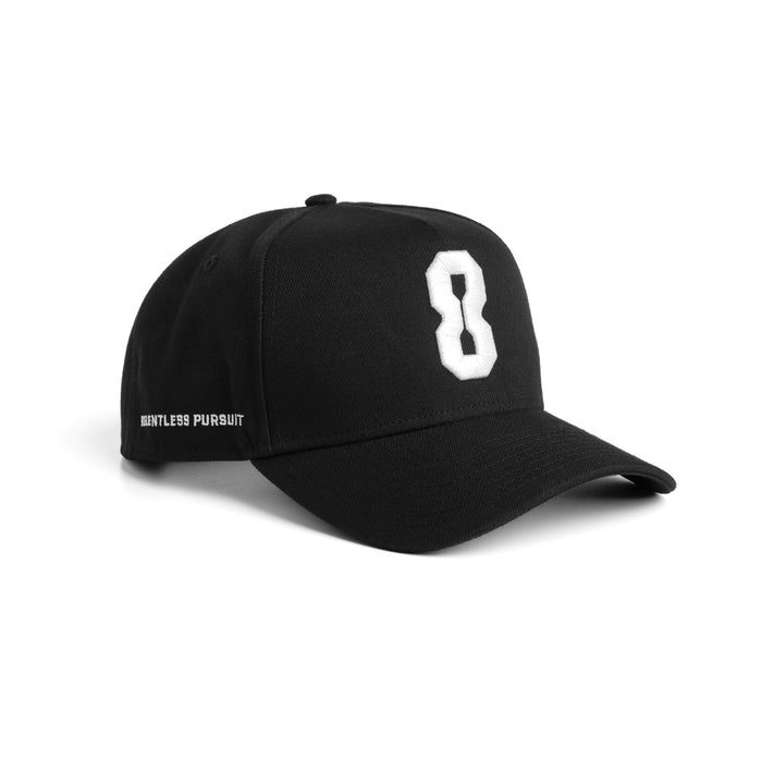Flatlay of Black New Era 9Forty A-Frame Hat with white '8' logo, displayed on stand against white background