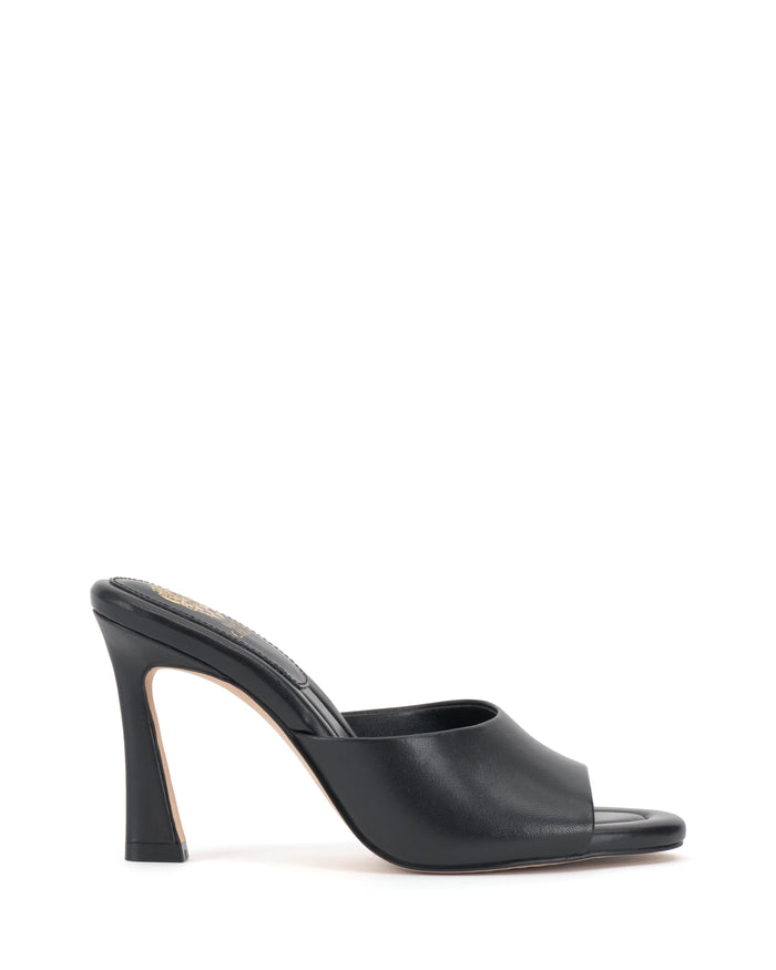 The Vince Camuto Paigely Mule is a black high-heeled minimalist mule featuring an open toe and a sleek, flared heel design, shown in side profile on a white background.