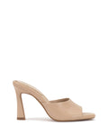 The Vince Camuto Paigely Mule is a beige, open-toe minimalist sandal showcasing a flared heel and a slip-on design with a pillow footbed, displayed against a plain white background.