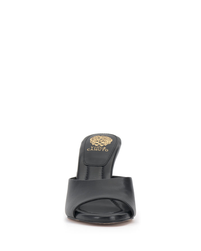 Front view of the Vince Camuto Paigely Mule in black, featuring a minimalist design with a single wide strap, gold Vince Camuto logo detail on the insole, and a pillow footbed for enhanced comfort.