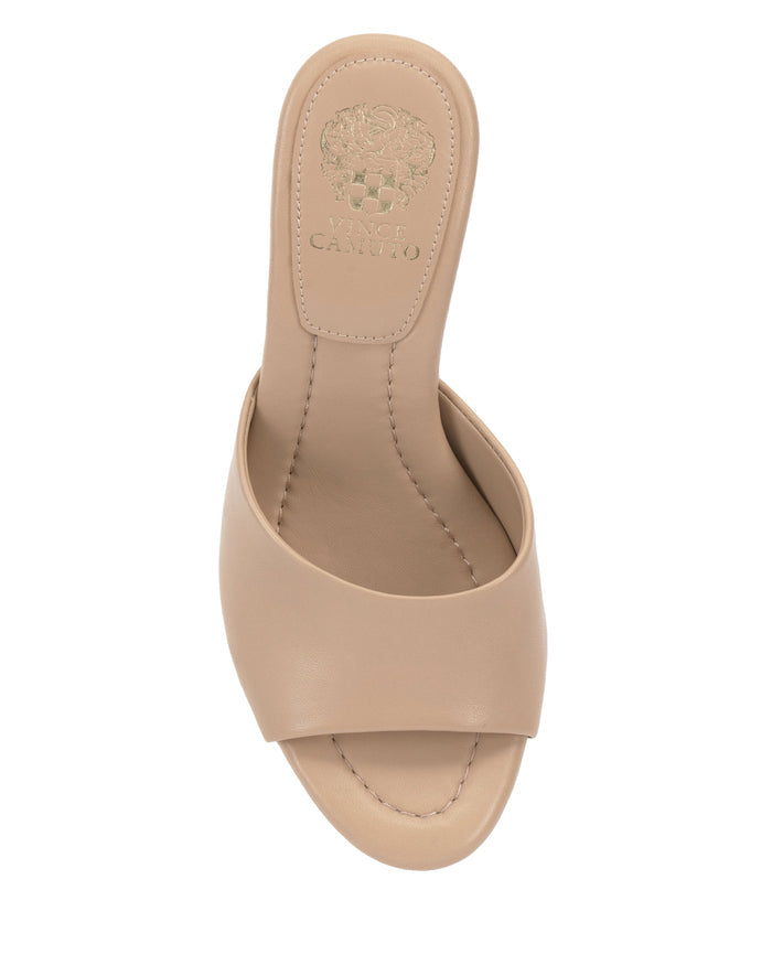 Top view of the Vince Camuto Paigely Mule, a beige open-toe minimalist sandal showcasing a wide strap with visible stitching, the Vince Camuto logo embossed on the insole, and a softly cushioned pillow footbed for added comfort.