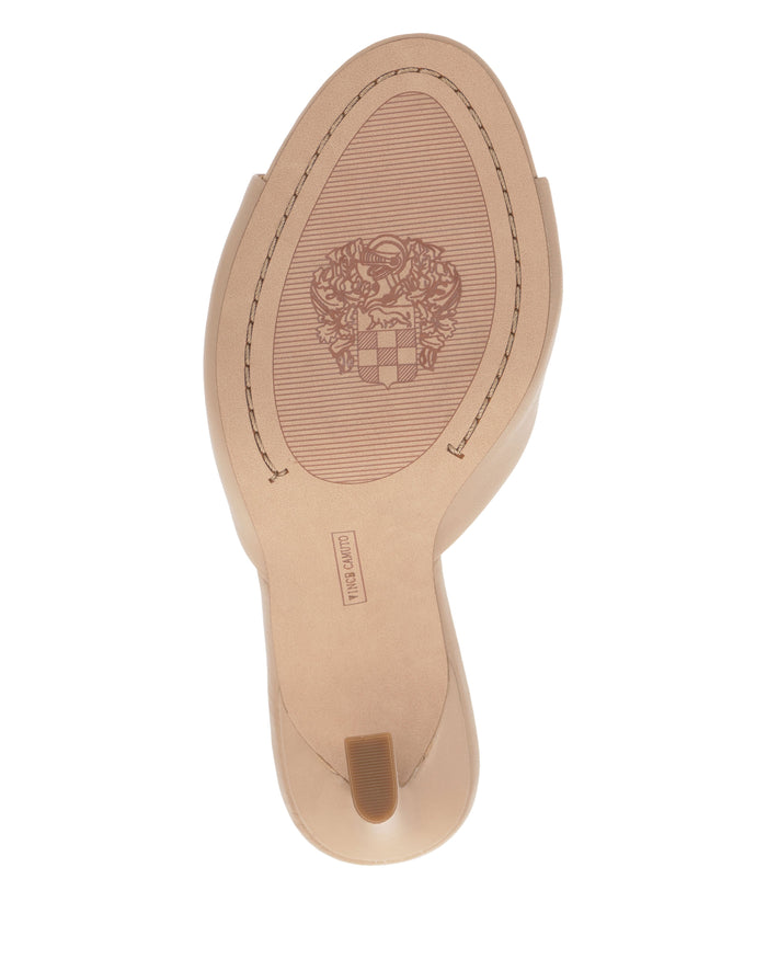 The image shows the sole of a beige Paigely Mule by Vince Camuto, featuring a textured oval section, an engraved crest design at the center, and a small rectangular label reading MAJOR PAN.
