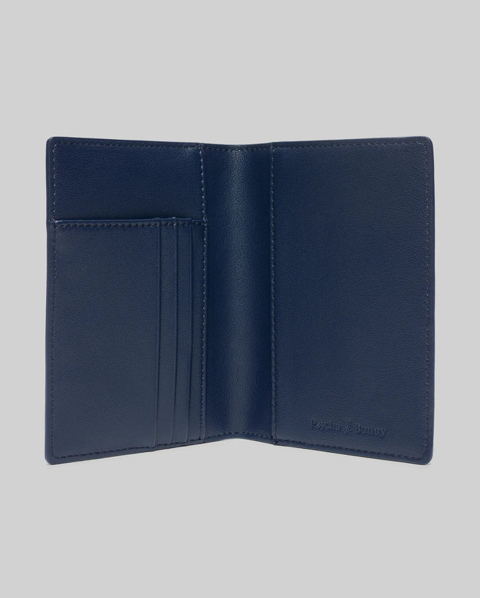 Navy Blue Grained Faux Leather Passport Holder, featuring a refined, open design with multiple interior card slots and a subtly embossed Psycho Bunny logo for premium style.