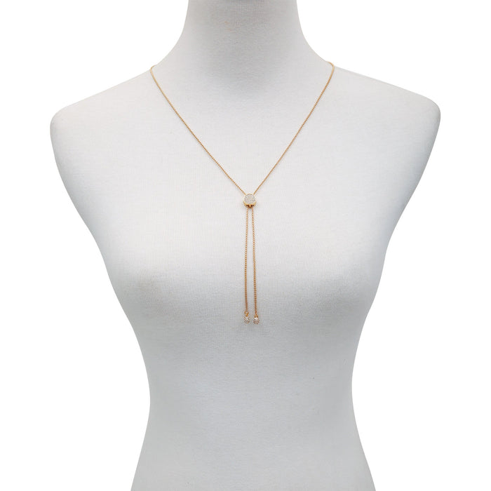 The Vince Camuto Pave Slider Bolo Necklace features a gold-tone design with a central round pendant and two delicate chains draping below, elegantly displayed on a white mannequin bust—a sophisticated statement piece that enhances any ensemble.