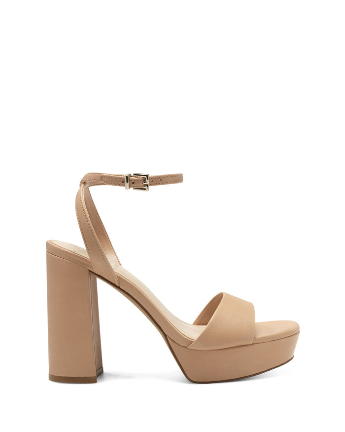 The Vince Camuto Pendry Platform Sandal features a single nude high-heeled sandal with a chunky heel, platform sole, open toe, and a slim ankle strap fastened by a small buckle—capturing the essence of classic ’70s style with its bold platform and vintage-inspired silhouette.