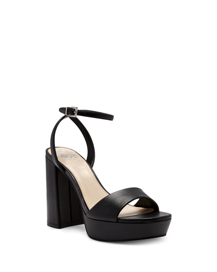 Introducing the Pendry Platform Sandal by Vince Camuto: a black leather platform sandal featuring a block heel, open toe, single toe strap, and an ankle strap with a silver buckle. Inspired by classic ’70s style, these retro sandals are designed with a beige insole and a sturdy platform base for bold yet comfortable wear.