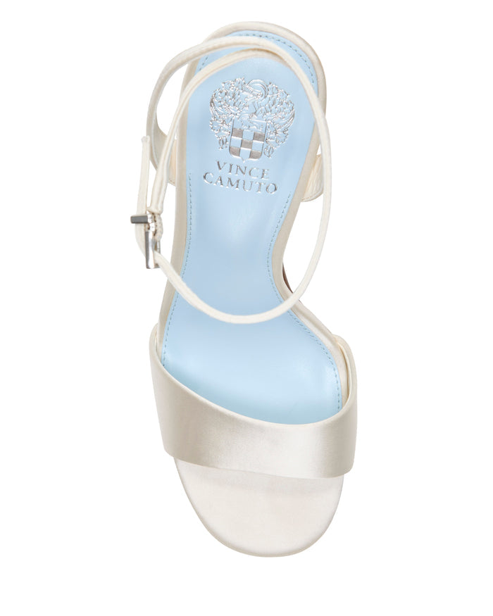 A top view of the Pendry Platform Sandal by Vince Camuto, featuring a white upper, blue insole, ankle strap, and the Vince Camuto logo printed on the footbed, with subtle retro-inspired details reminiscent of classic platform sandals.