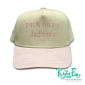 Cap with text 'put it on my dad's tab' and brand logo on a white background