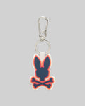 Rubber Bunny Keychain with a prominent navy Psycho Bunny skull and crossbones logo, accented by vibrant orange and pink outlines on a white rubber base, attached to a sleek silver carabiner clip.