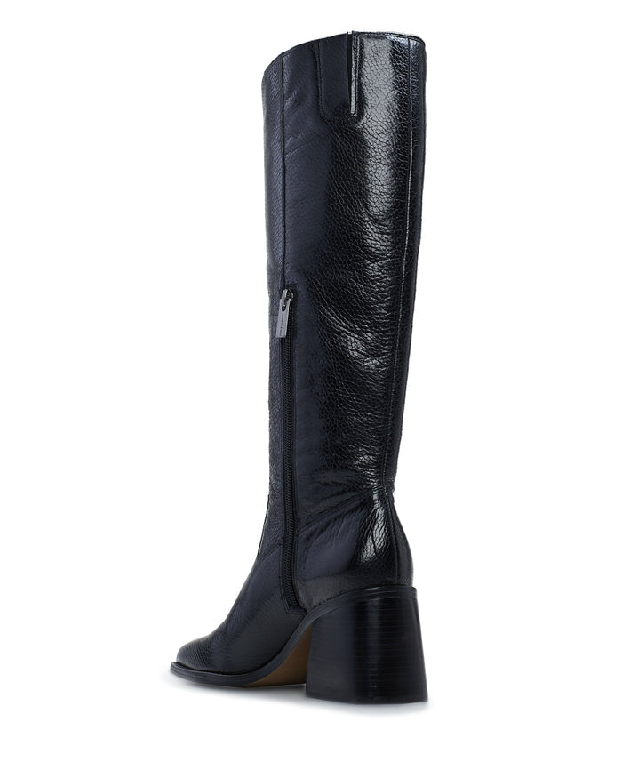 The Vince Camuto Sangeti Boot is a best-selling tall boot in black textured leather, featuring a square toe, side zipper, and chunky mid-height heel, shown from a rear side angle on a white background.