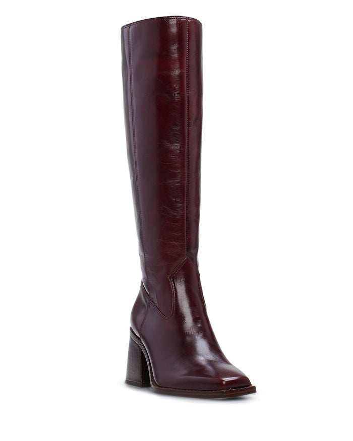 The Sangeti Extra Wide Calf Boot by Vince Camuto is showcased from a slight side angle against a white background, highlighting its shiny burgundy leather construction, block heel, and rounded square toe.