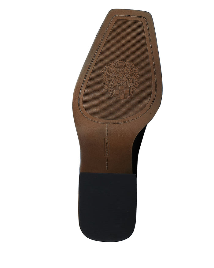 The image shows the bottom of a brown Vince Camuto Sangeti Wide Calf Boot with a black heel. The sole features a textured pattern, an emblem, and a rectangular embossed label near the arch, reflecting craftsmanship reminiscent of classic block heel boots.
