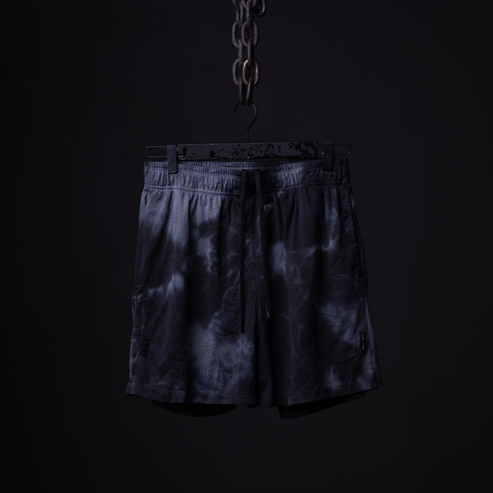 SM'21 Tie Dye Mesh Liner Short in navy, hanging from chain against black background