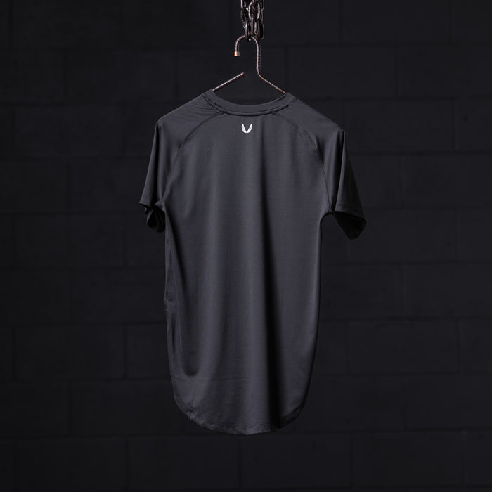 SM'22 Established Tee in charcoal gray, displayed on hanger against dark background, back view