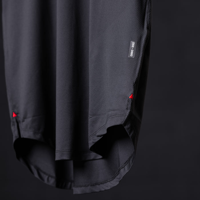 SM'22 Established Tee in charcoal, detail shot of hem and side seam with red accent