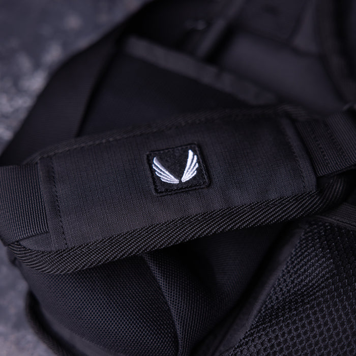 SM'23 Crossbody in black, close-up detail of logo patch