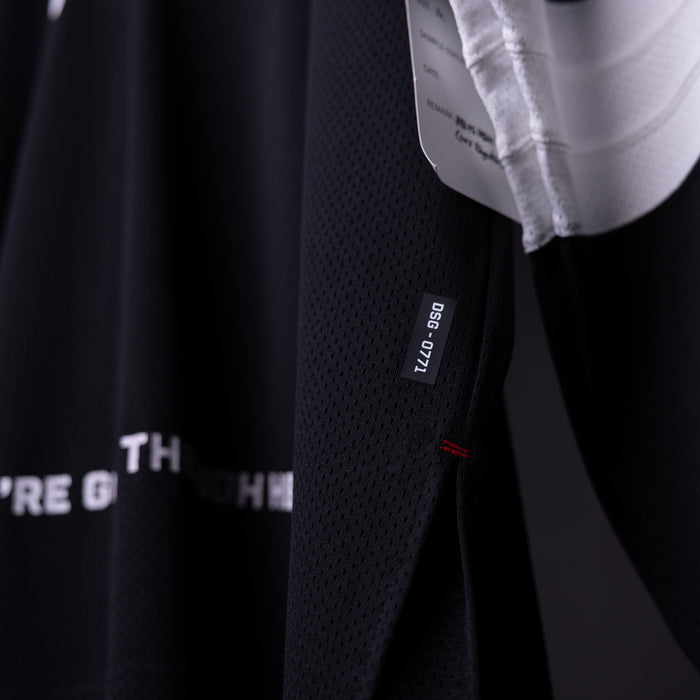 SM'23 Long-sleeve Jersey in black, detail shot of fabric texture and care label
