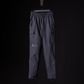 flatlay SP'20 Cargo Track Pant in charcoal grey with cargo pockets, front view