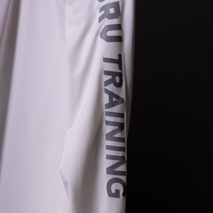 SP'20 Long Sleeve Shirt in white, sleeve detail closeup showing 'RUN TRAINING' text