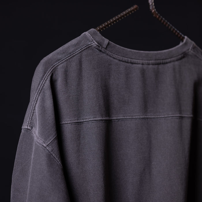 Stone washed oversized tee in charcoal gray, displayed on hanger from front angle