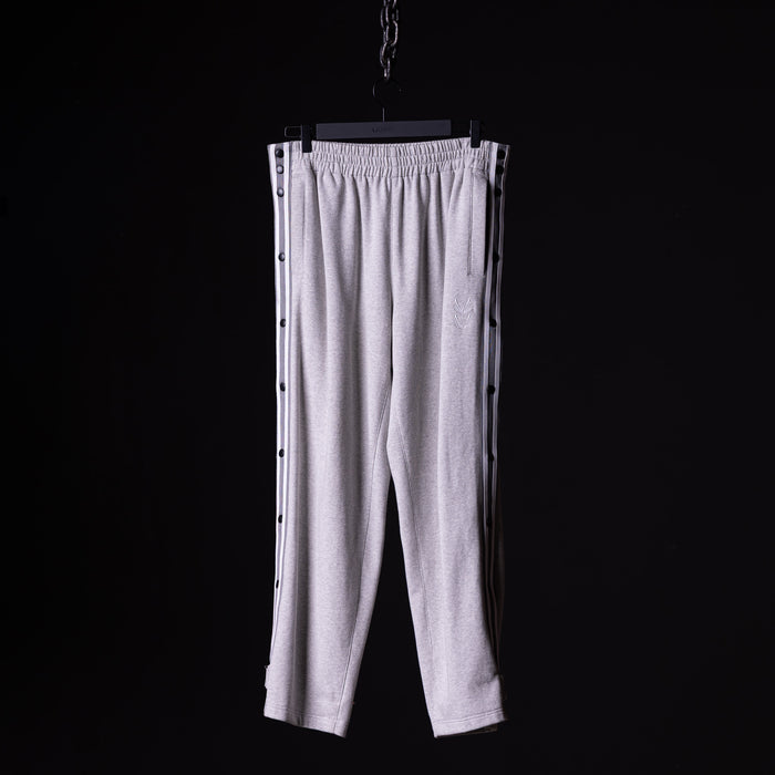 SP'22 Tearaway Jogger in light grey, displayed on hanger against black background