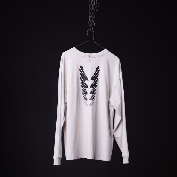 SP'23 Graphic Long Sleeve white long-sleeve tee with black feather wing design, hung on hanger