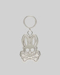 Silver metallic Spinning Bunny Keychain featuring the iconic Psycho Bunny skull and crossbones logo design with a hollowed-out center, attached to a classic key ring.
