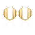 Pair of Stacked Link Hoop Earrings by Vince Camuto in a gold-tone finish, showcasing a ribbed, oval-shaped design with a hinged closure at the top. Displayed on a white background with a subtle reflection beneath, these earrings add modern style and sophistication to any look.