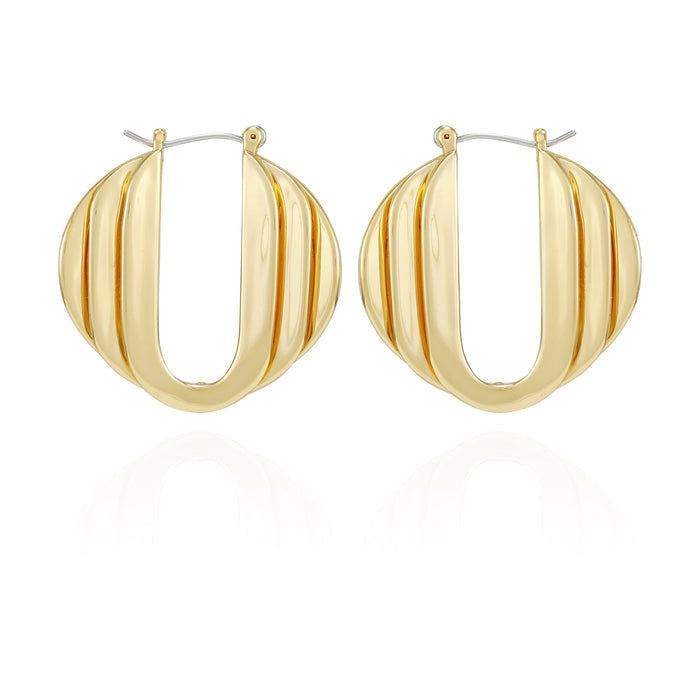 Pair of Stacked Link Hoop Earrings by Vince Camuto in a gold-tone finish, showcasing a ribbed, oval-shaped design with a hinged closure at the top. Displayed on a white background with a subtle reflection beneath, these earrings add modern style and sophistication to any look.