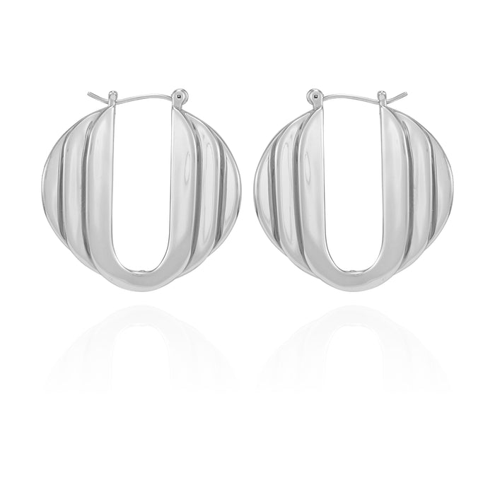 A pair of Vince Camuto Stacked Link Hoop Earrings featuring a ridged, domed design and a sleek silvertone finish, showcased against a white background with a subtle reflection below.
