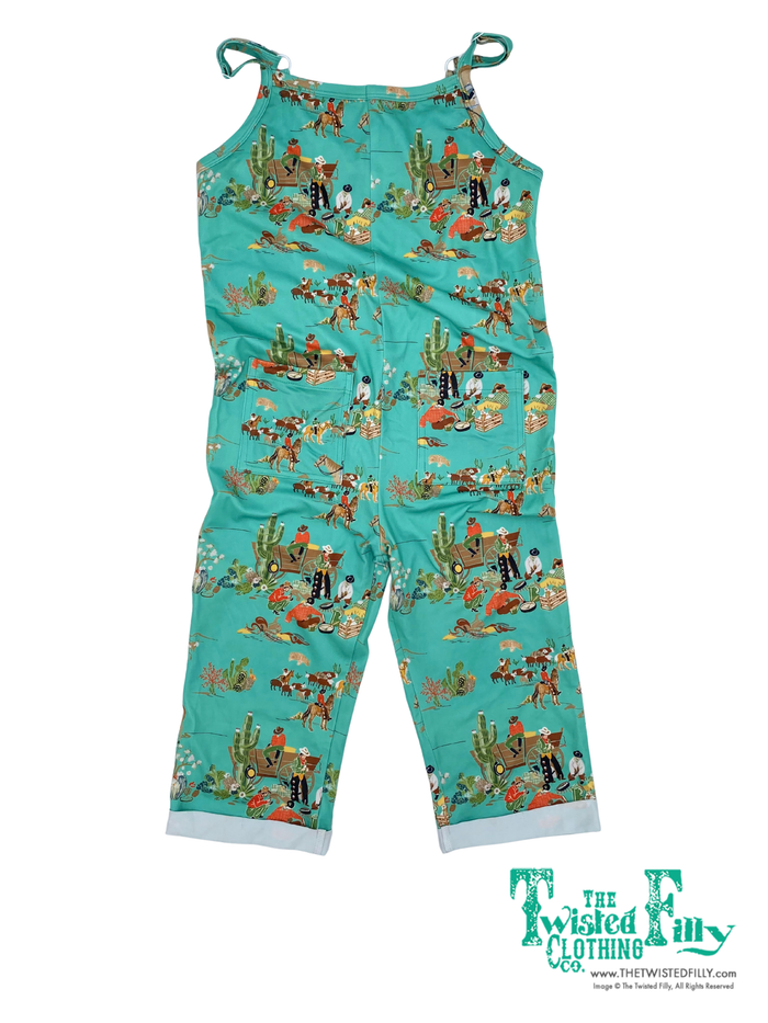 Sleeveless turquoise romper with cowboy wagon pattern