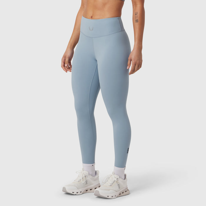 W002 LYCRA® ADAPTIV legging in light sky, worn with white sneakers, side view